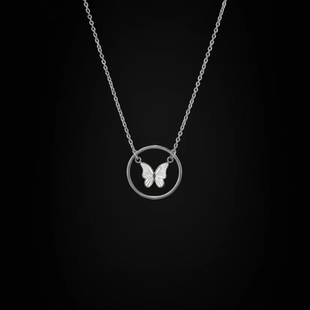 Shinora Midnight Fly Pendant – silver butterfly necklace with circular charm on black background, perfect for modern women from Shinora