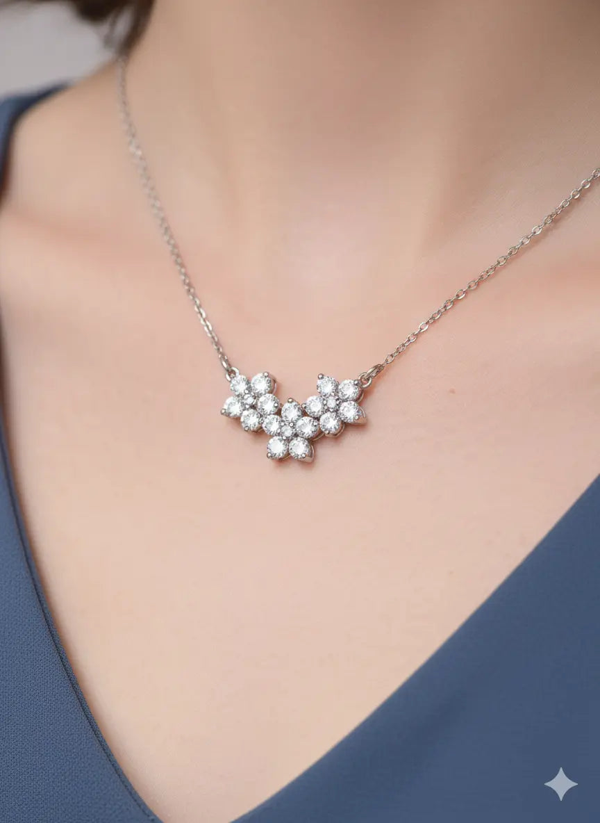 Elegant silver floral pendant necklace worn on a woman's neck, featuring sparkling crystal stones and a delicate chain from Shinora