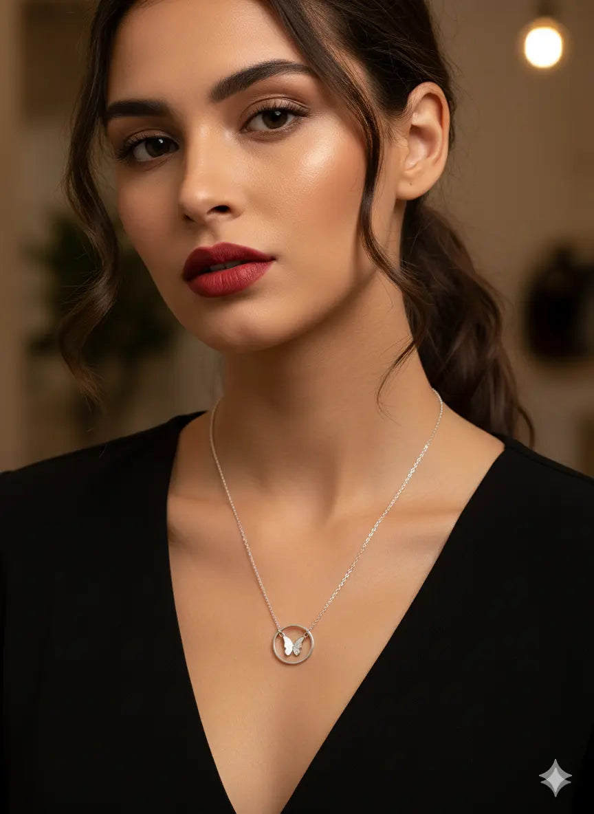 Model wearing the Shinora Midnight Fly silver butterfly pendant with deep neckline – chic and timeless jewelry piece from Shinora
