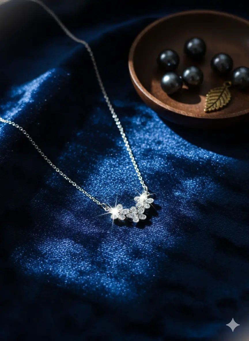 Silver floral crystal pendant necklace placed on luxurious blue velvet fabric, emphasizing its shine and premium craftsmanship from Shinora
