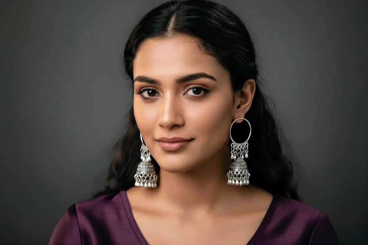 Model wearing Mayuri Jhumka – oxidized silver traditional hoop jhumka earrings paired with a plum ethnic outfit, perfect for festive and cultural occasions from Shinora