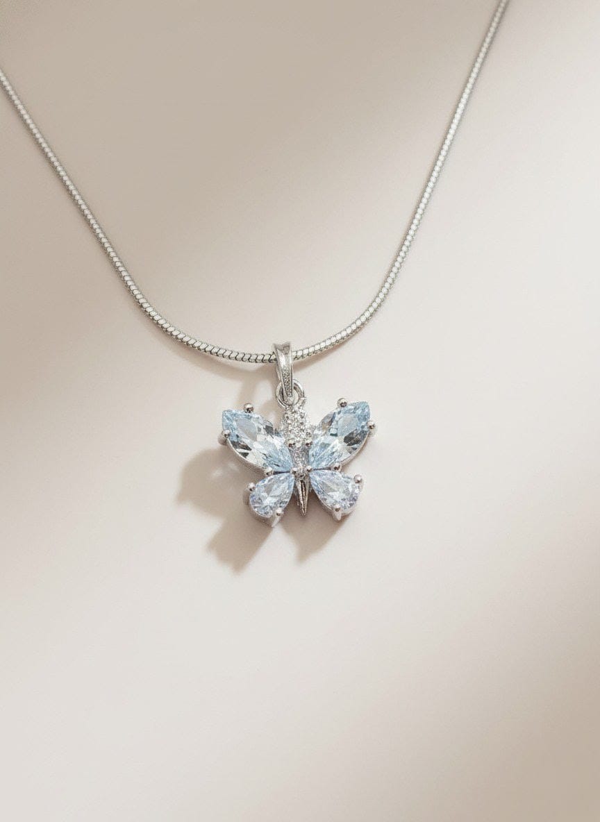 Model displaying The Fluttering Charm silver butterfly pendant necklace with clear stones, styled with a black neckline for elegance  by shinora