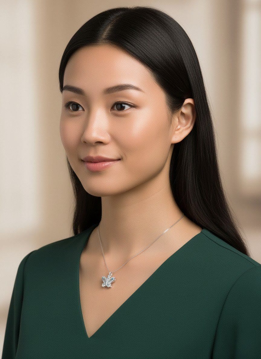 Side view of woman wearing The Fluttering Charm crystal butterfly necklace on a silver chain, complementing a green outfit beautifully  by shinora