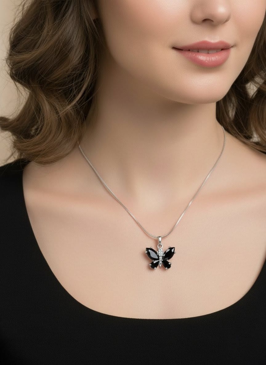 Model wearing The Fluttering Charm butterfly necklace with black gemstones and silver detailing, styled with a black outfit for a modern chic look  by shinora