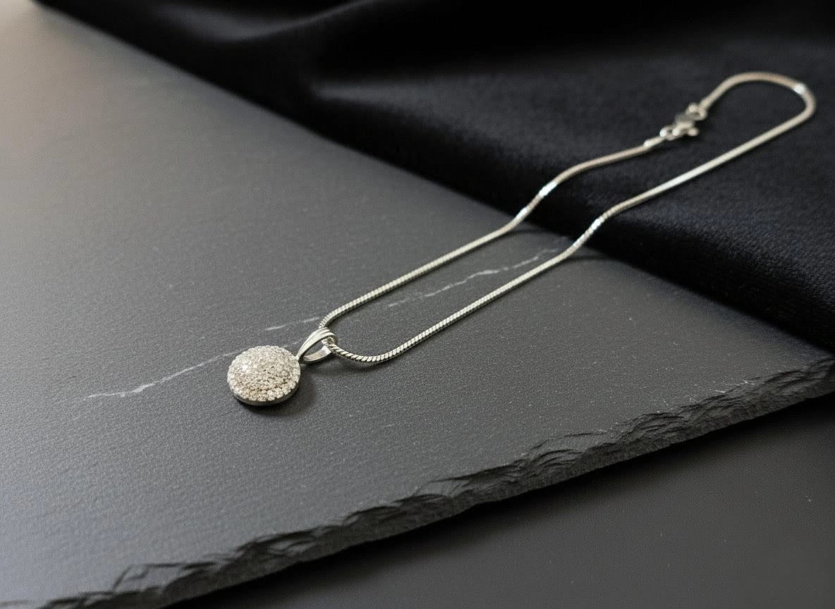 Luxury silver chain necklace with circular crystal pendant showcased on dark slate with black velvet fabric – The Celeste Necklace by The Fluttering Charm by Shinora