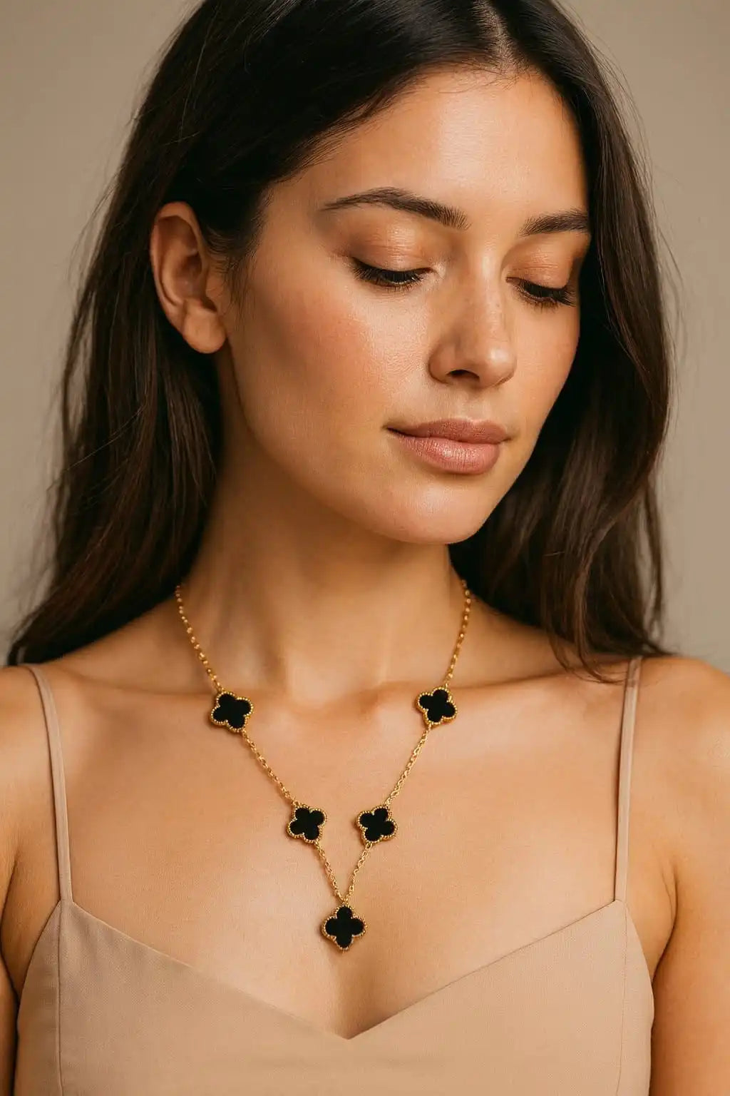Woman wearing gold clover necklace with black charms, showcasing adjustable fit and elegant jewelry design from shinora