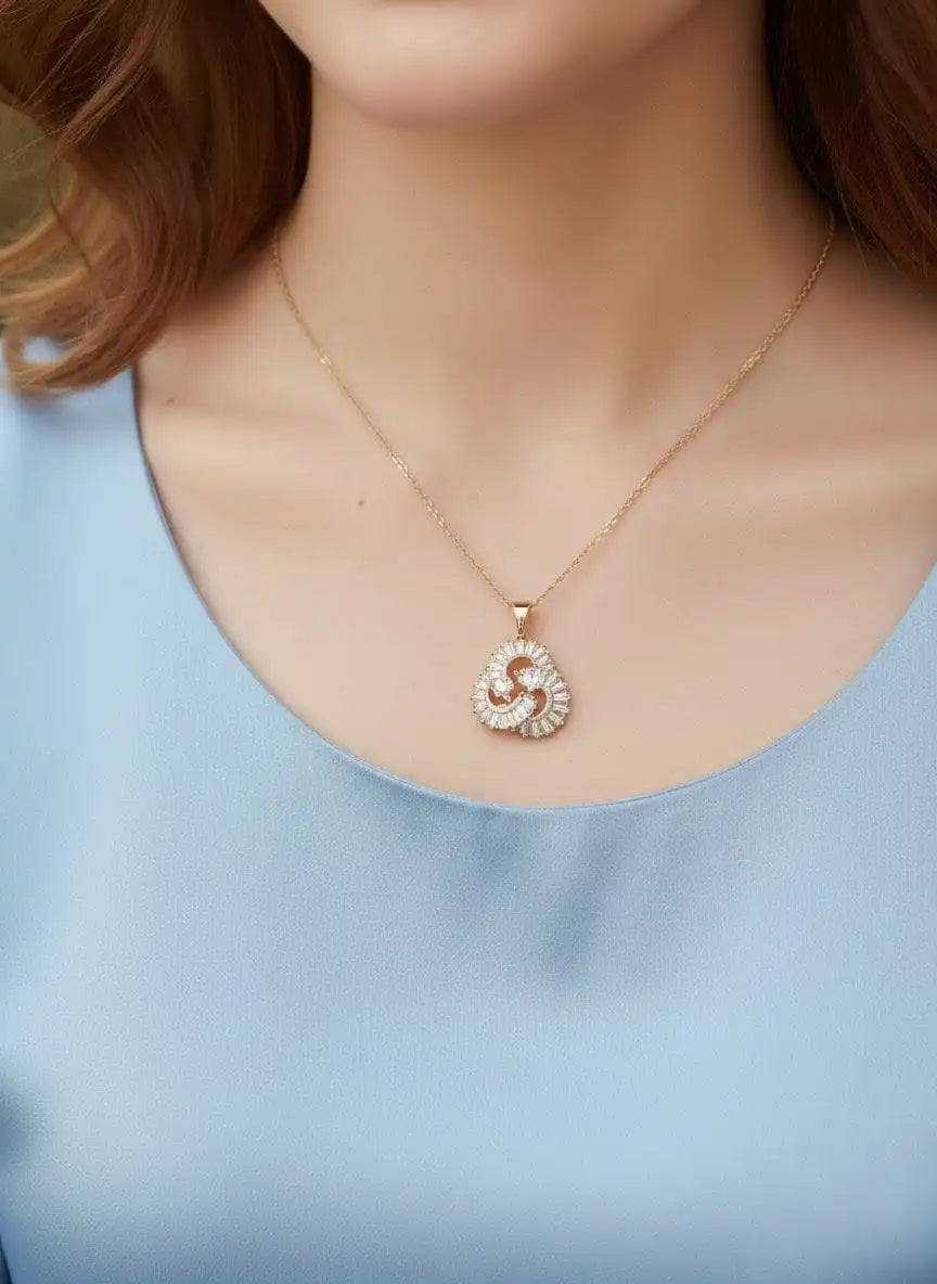 Close-up of Momentum Pendant by Shinora – luxurious gold swirl design with sparkling stones for timeless elegance from Shinora