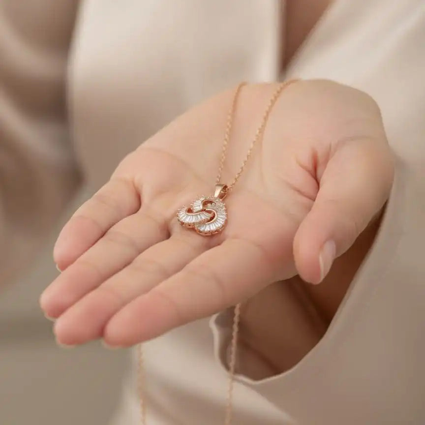 Hand holding Shinora Momentum Pendant – stylish gold-plated necklace showcasing luxury and craftsmanship from Shinora